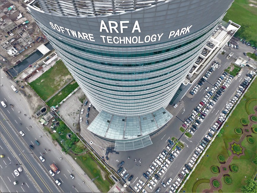 Drone shot of Arfa Software Technology Park skyscraper with cars and road below